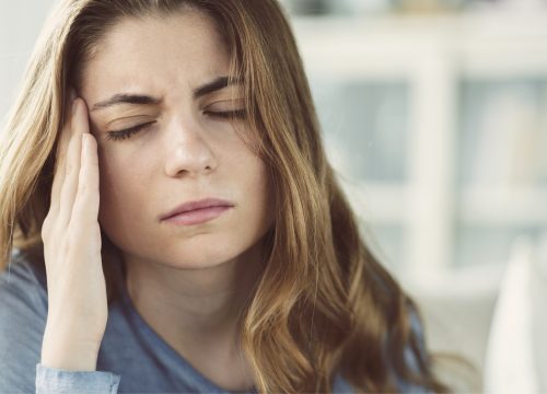 Woman with horrible migraine headache.